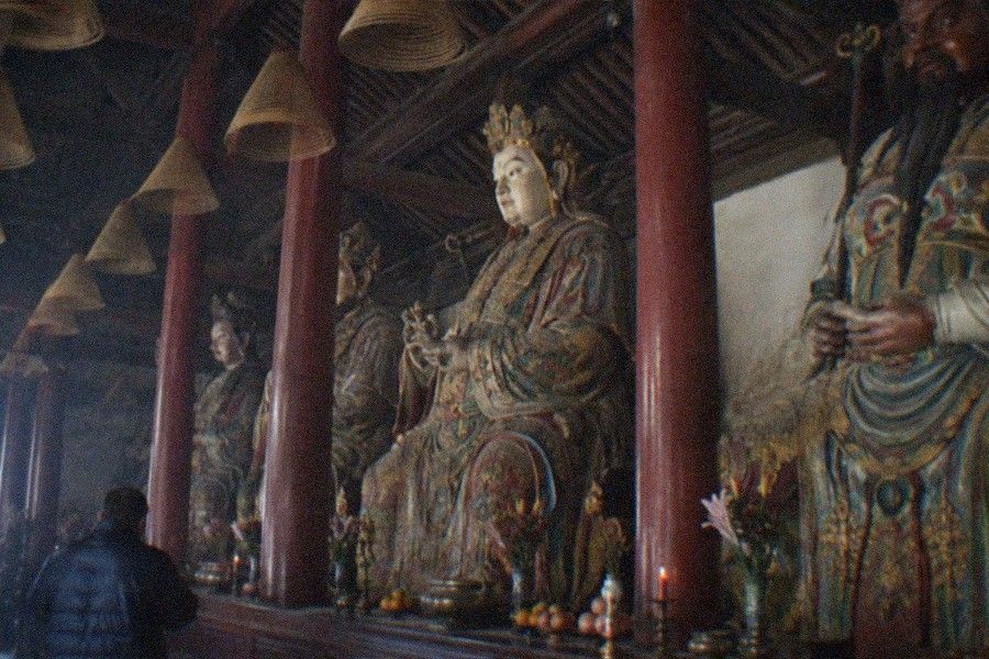 Courtyard of the Beijing Folklore Museum at Dongyue Temple with stone steles lining a walkway between worship halls