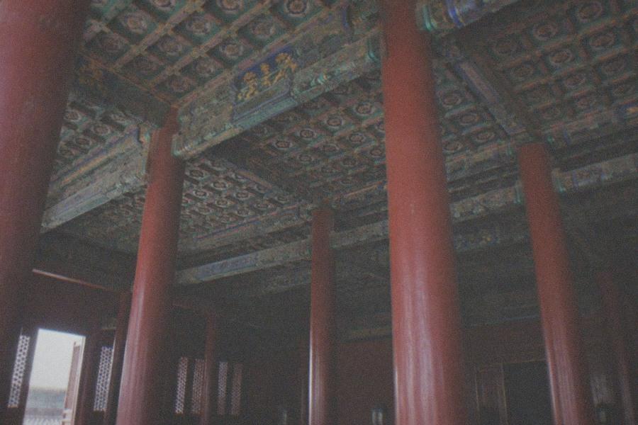 Golden rooftops and red palace walls of the Forbidden City under a clear sky