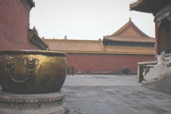Lakeside hutong street with grey walls and traditional gateways near Shichahai