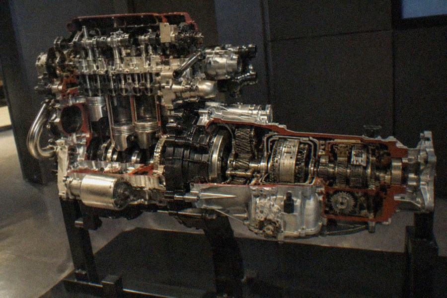 A cutaway engine display beside interactive panels in a bright exhibition hall