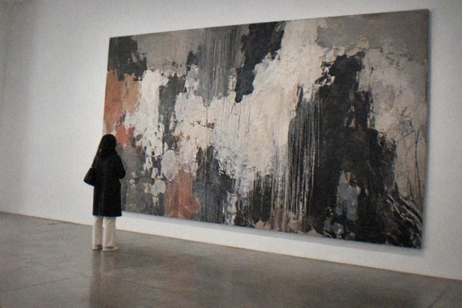 Bright gallery hall with abstract paintings hung in a row