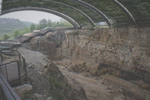 Excavated limestone hillside at the Zhoukoudian Peking Man site under a wide sky