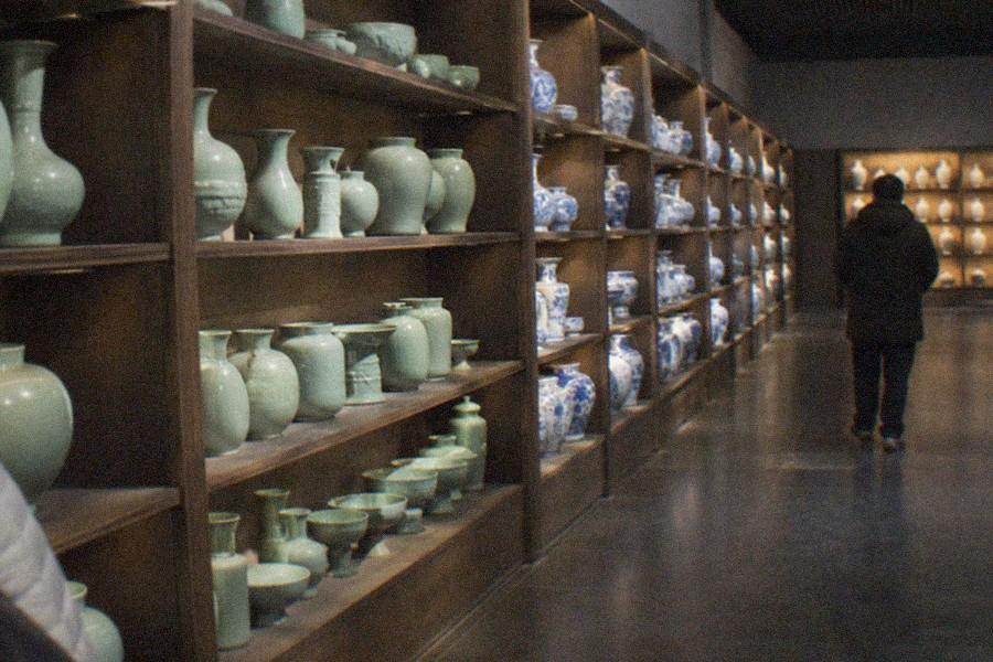 A display of classical Chinese hardwood furniture arranged in a museum gallery