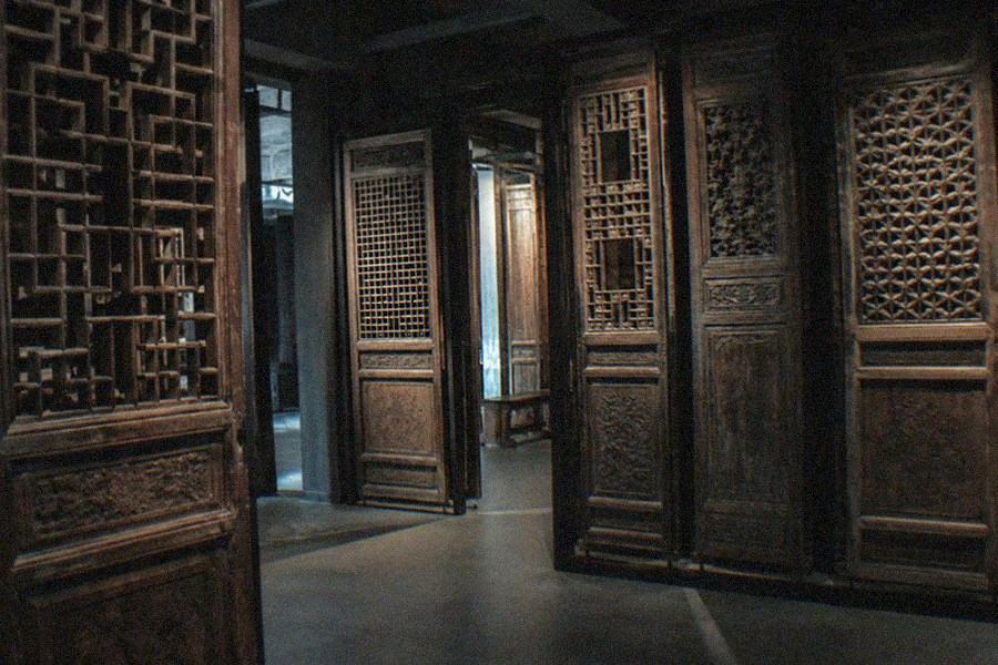 Ceramic vessels from several Chinese dynasties displayed in glass cases