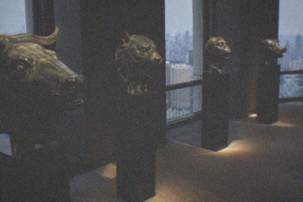 A bronze animal head sculpture from the Old Summer Palace zodiac fountain displayed on a museum plinth