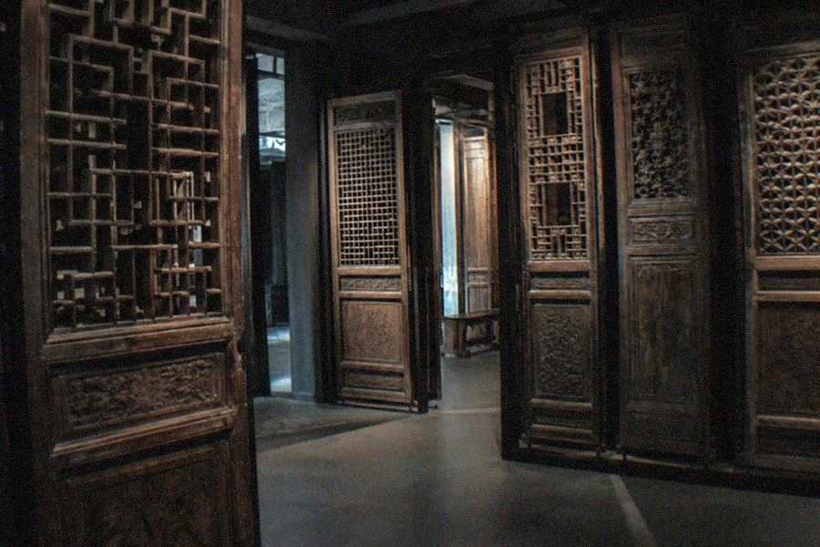 A display of Chinese ceramics inside the Guanfu Museum, with glazed vessels arranged on plinths under gallery lighting