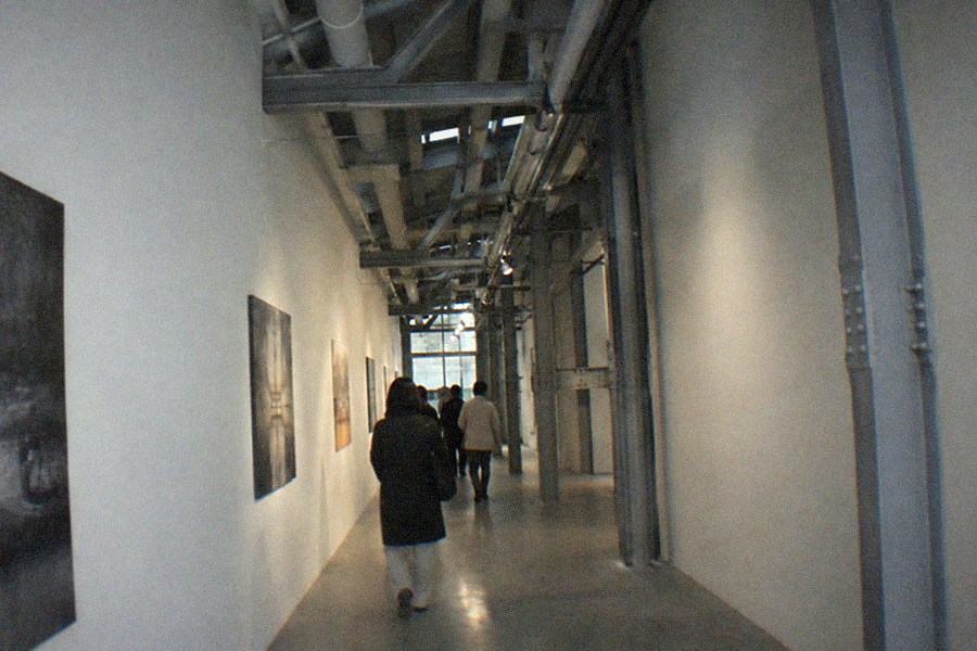 Wide walkway between converted factory buildings with bicycles parked along a wall