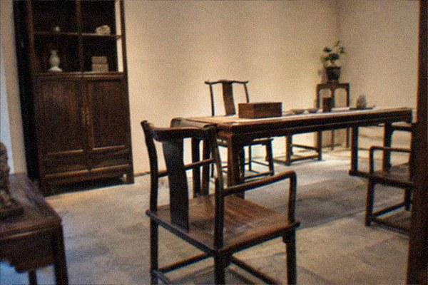 Antique Chinese hardwood furniture arranged in a private museum gallery