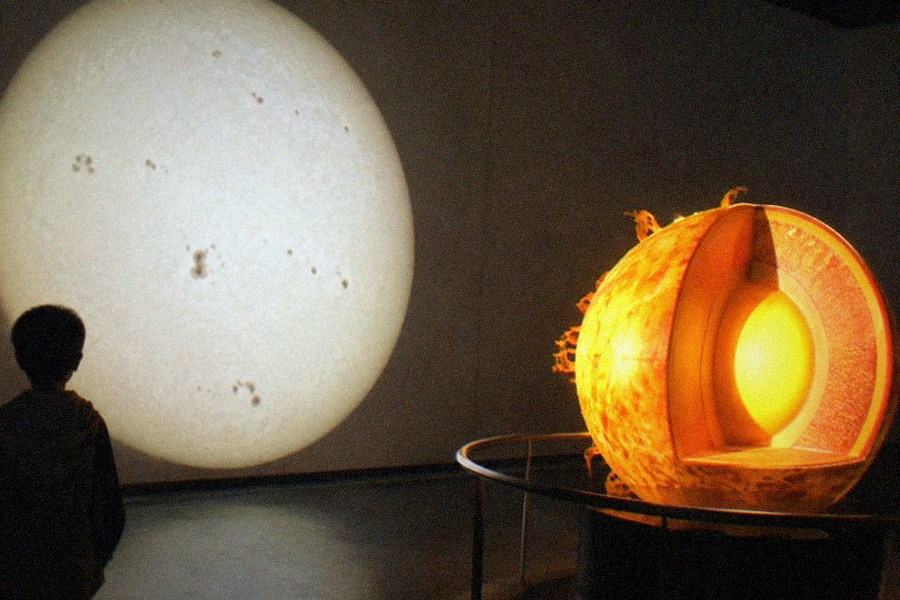A hands-on science exhibit with levers and lights in a museum hall