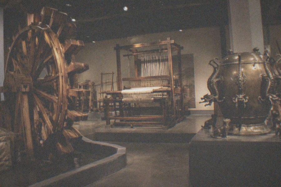 A vintage locomotive displayed in a large exhibition hall