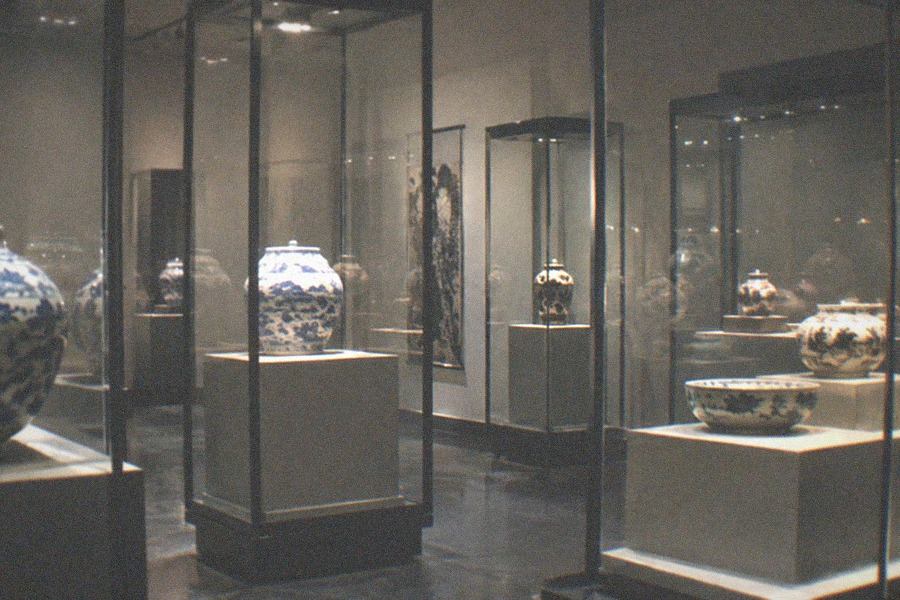 A modern museum hall with a large stone archway displayed inside