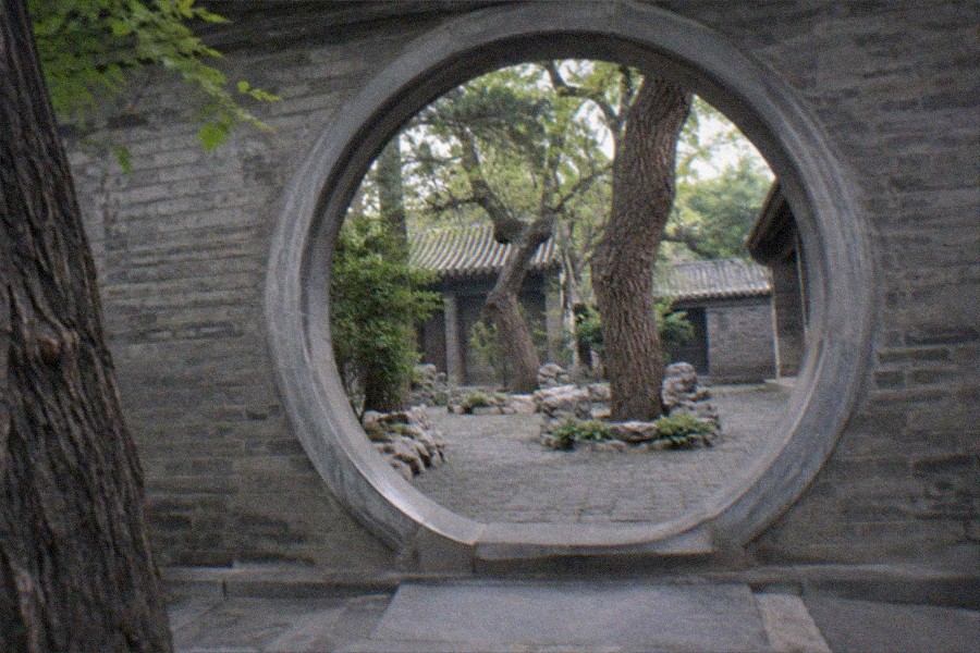 Courtyard halls of Prince Gong’s Mansion with visitors walking between the grey-tiled roofs in Beijing